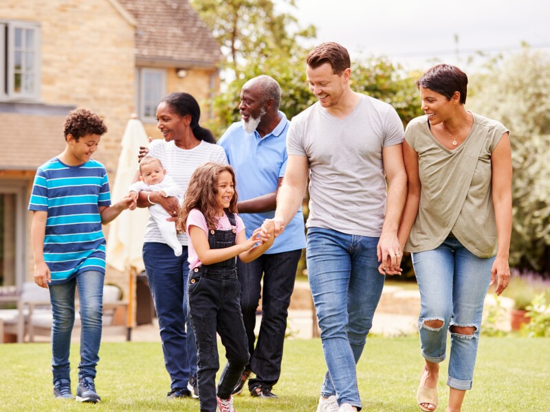 Smiling Multi-Generation Mixed Race Family In Garden At Home Together