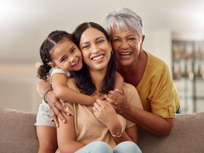 Grandmother, mom and child hug in a portrait