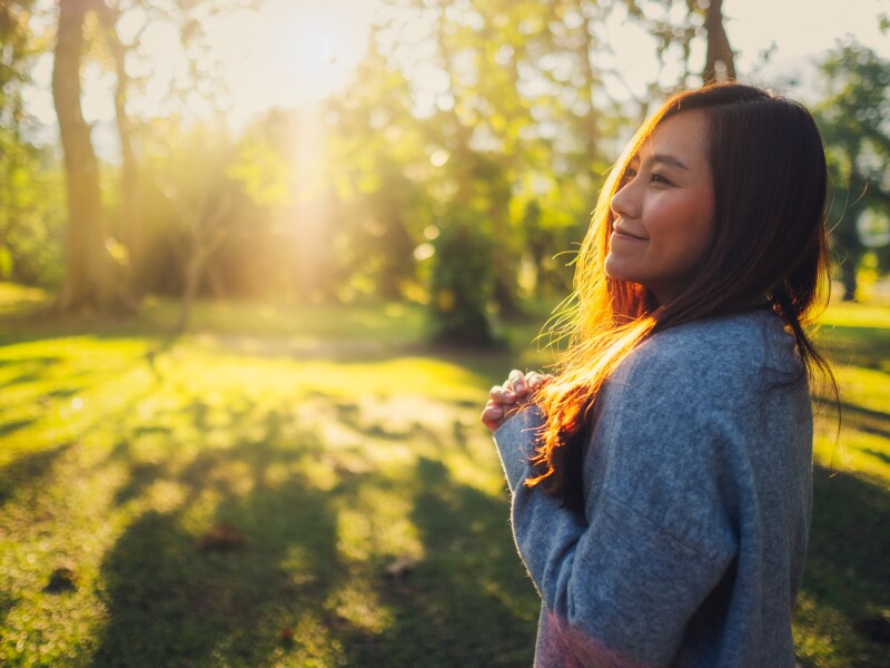 Portrait image of a beautiful asian woman standing among nature