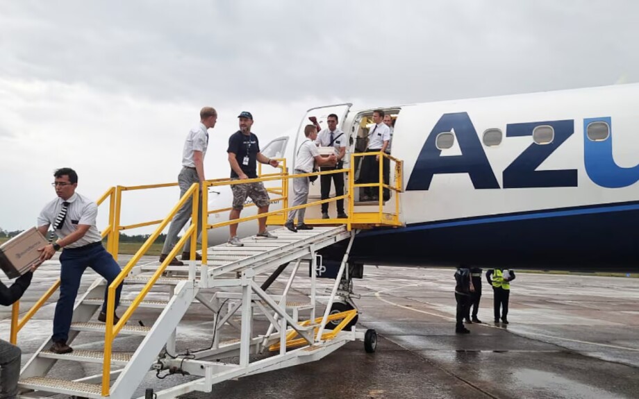 Missionaries from The Church of Jesus Christ of Latter-day Saints help unload emergency supplies from an Azul airplane at a military airport in Canoas, Brazil, following severe flooding in the Rio Grande do Sul state, Brazil, May 8, 2024.