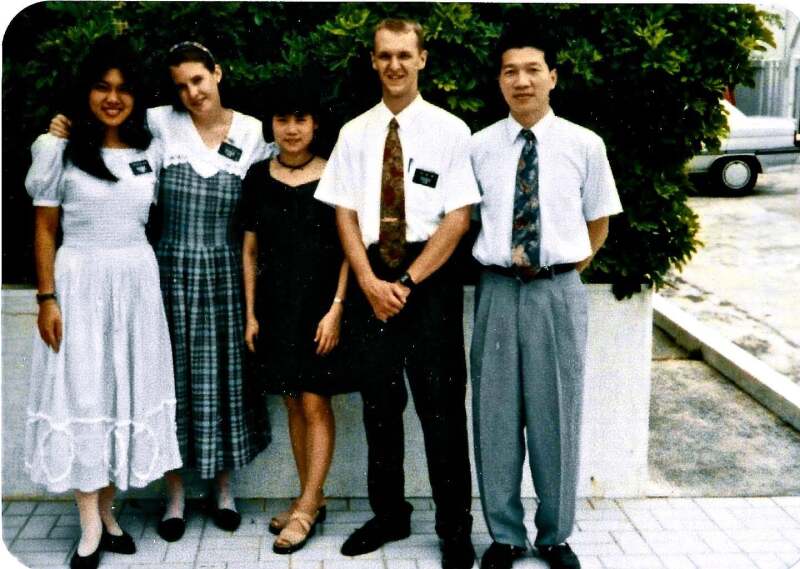 Two sister missionaries, a young woman, and two elder missionaries smile in Taiwan.