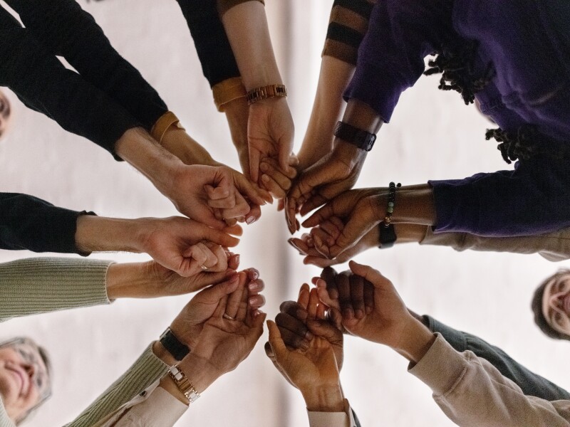 People with fist put together during support group session