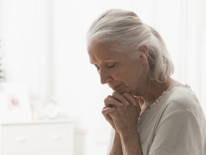 Senior Caucasian woman praying