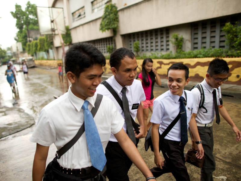 Four Latter-day Saint elders walk outside in the Philippines