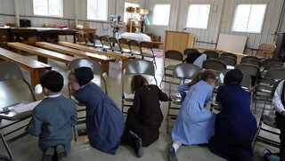 The Amish families meeting together as a Latter-day Saint group.