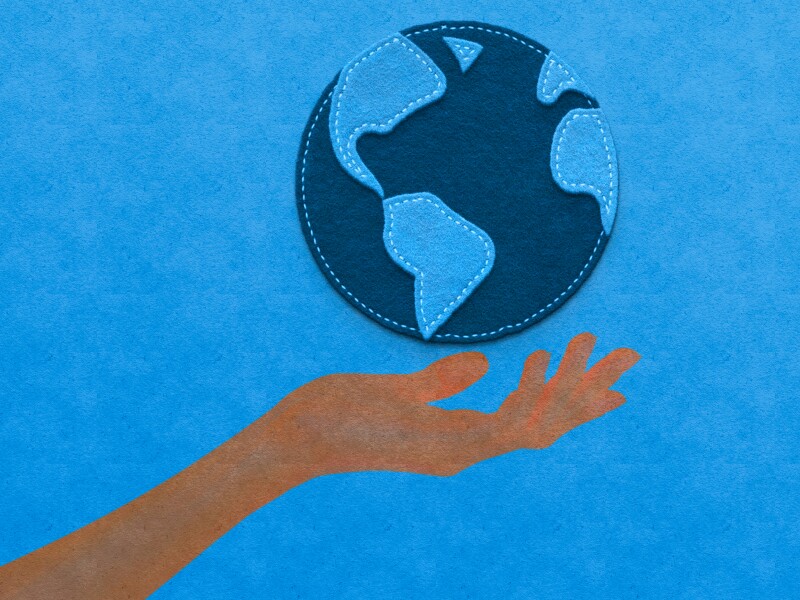 paper work human hand holding a planet earth globe