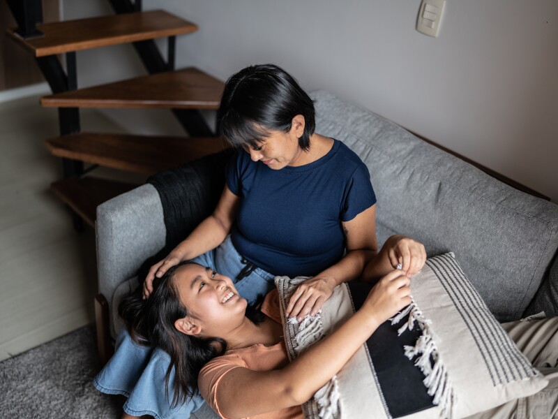 Mother taking to daughter at home