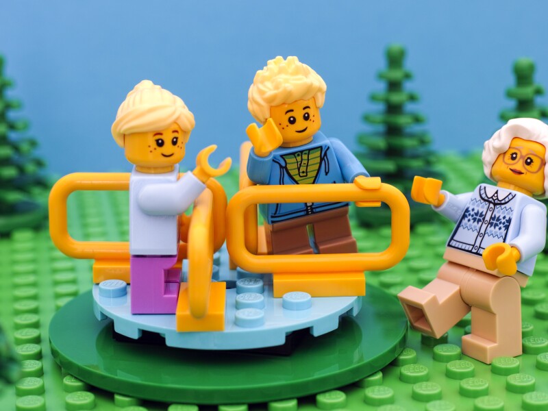 Lego kids play in playground with their grandmother