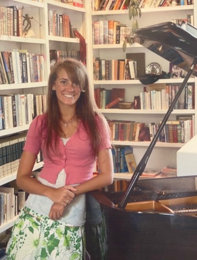 Ashley with childhood piano.
