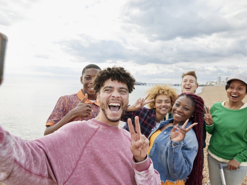 Group of friends taking selfie on sunny beach