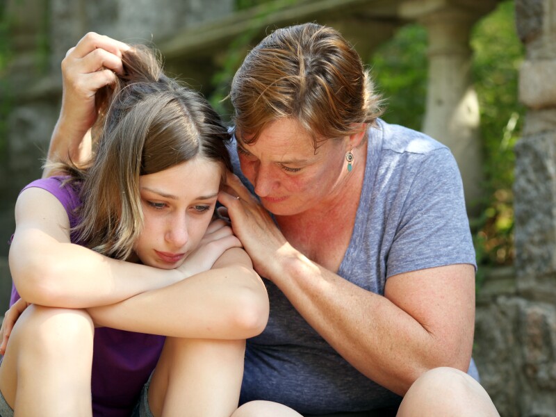 Mother consoling dejected daughter