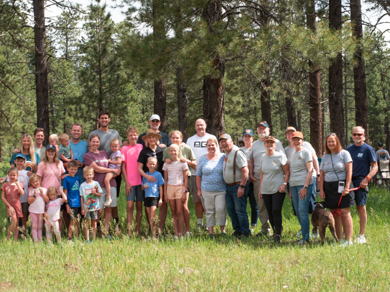 The Montoya family and their friends from Provo smile in the campground where they met 50 years ago.