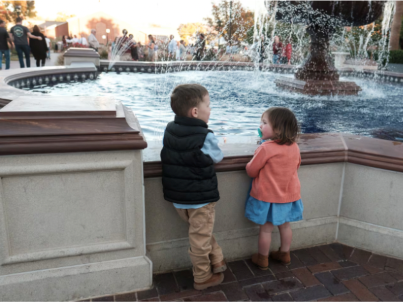 George Neville, 4, and Hazel Neville, 2, of Medford, Oregon, look at the fountain outside the St. George Utah Temple of The Church of Jesus Christ of Latter-day Saints on the last day of public tours Saturday, November 11, 2023, in St. George, Utah.