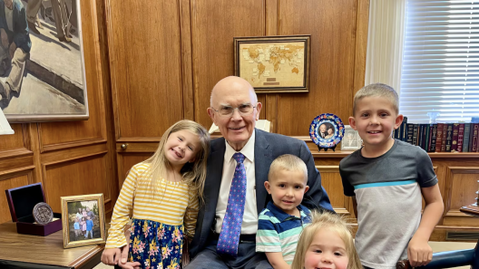 President Dallin H. Oaks smiles with four great-grandchildren in his office at the Church Administration Building.