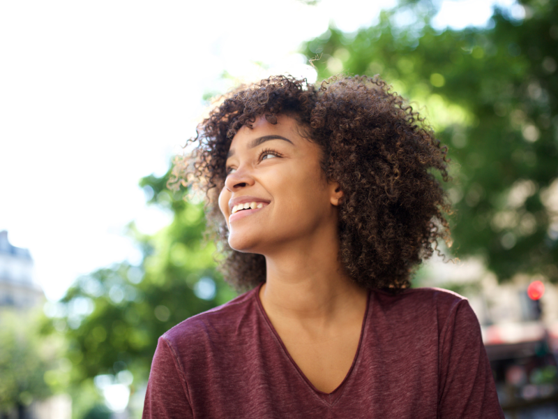 A confident Black woman with curly hair