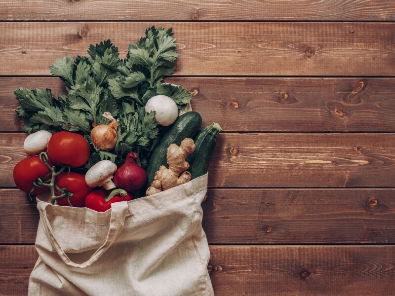 Fresh vegetables in the eco cotton bag at the kitchen counter