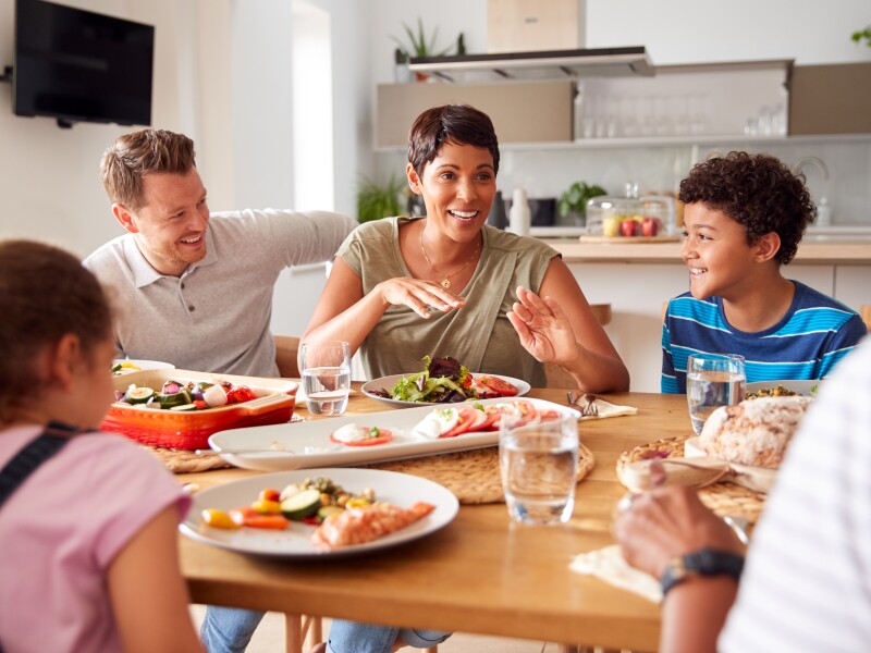 Multi-generation,Mixed,Race,Family,Eating,Meal,Around,Table,At,Home