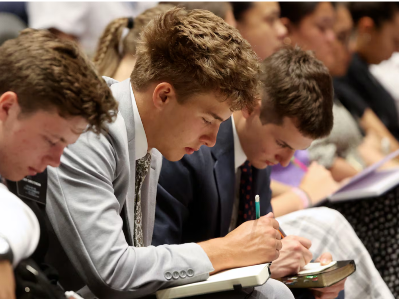 Elders take notes as Young Women General President Emily Belle Freeman speaks at the Provo Missionary Training Center in Provo, Utah, on Tuesday, May 27, 2025.