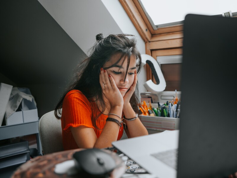 female teenager feeling stressed studing at home.E learning.Home schooling