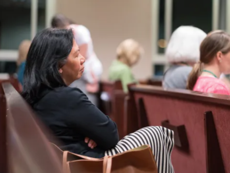 A woman pondering during an LDS sacrament meeting