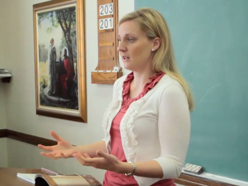 A woman teaches Relief Society
