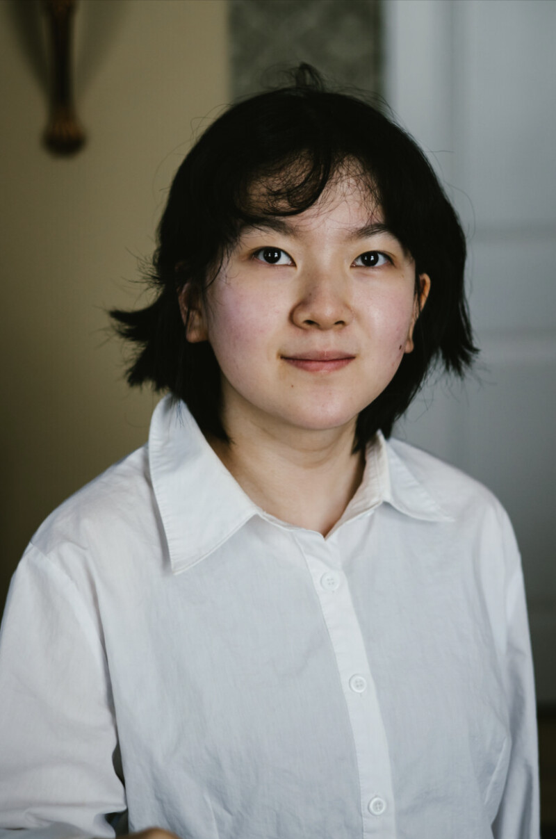 A portrait of a young woman smiling.