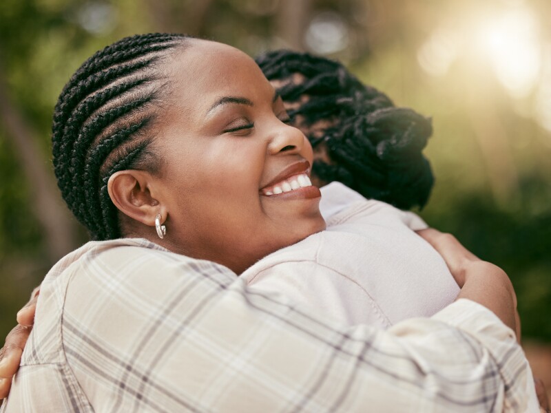 A mother and daughter embrace.