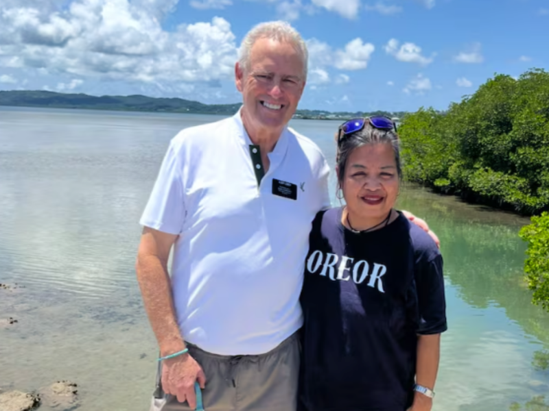 Elder Scott Lieber and Shielly Oilouch take a photo in Palau in July 2025 near where he saved her live in 1983.