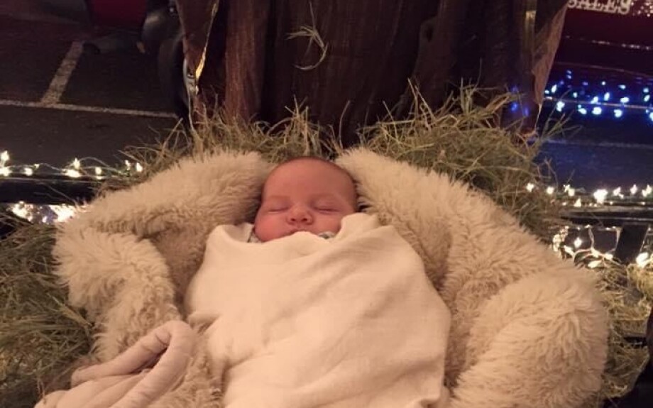 Inside the float, baby Jesus asleep in the manger.