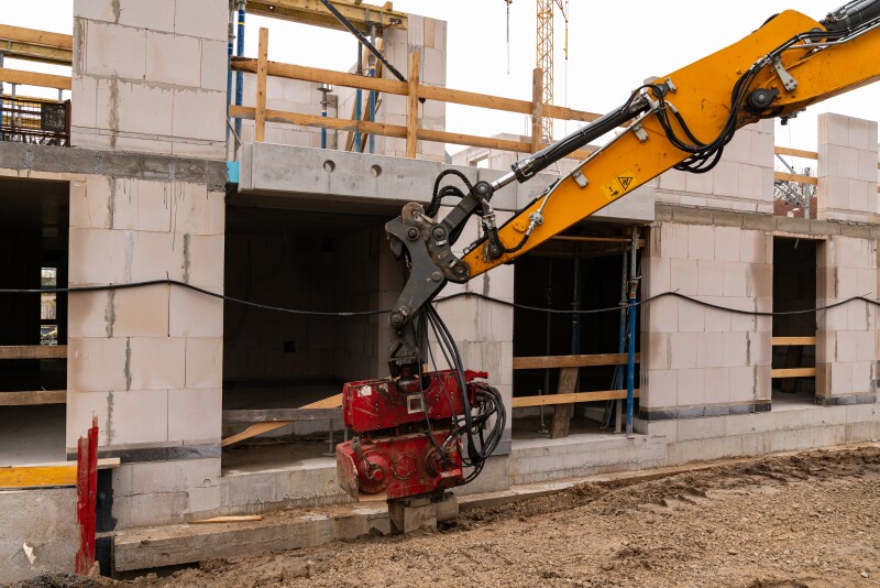 Soil compaction at the foundation of a building under construction.