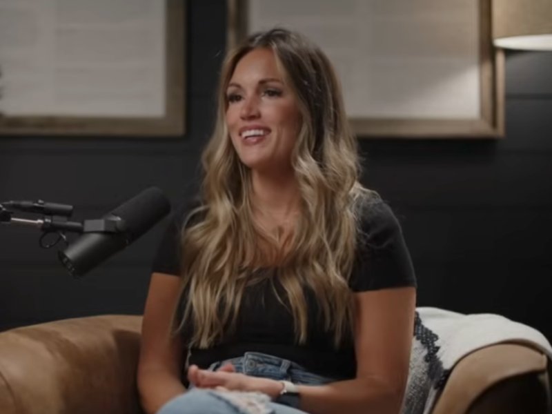 Ashly Stone sits in front of a microphone