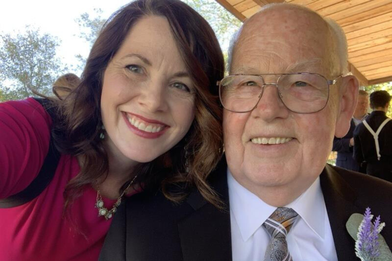 A woman smiles with her father.