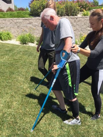 President Bingham walking with the help of crutches