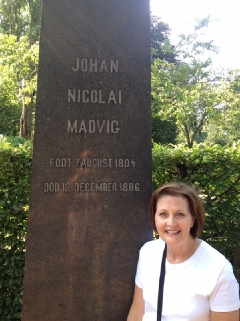Sister Burton at the headstone of the stranger who helped her great-great grandfather's family.