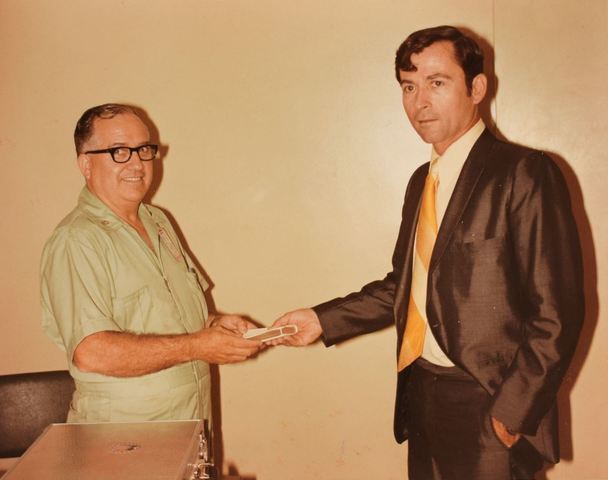 M. Edward Thomas, left, hands astronaut John Young a Book of Mormon (triple combination) to take to the moon on the Apollo 16 mission in 1972.