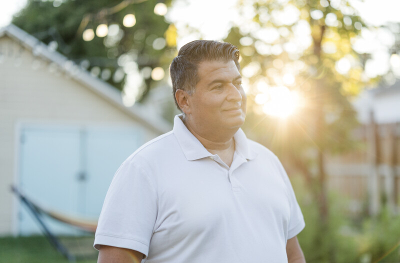 Ruben Arredondo smiles in his yard in Provo, Utah.
