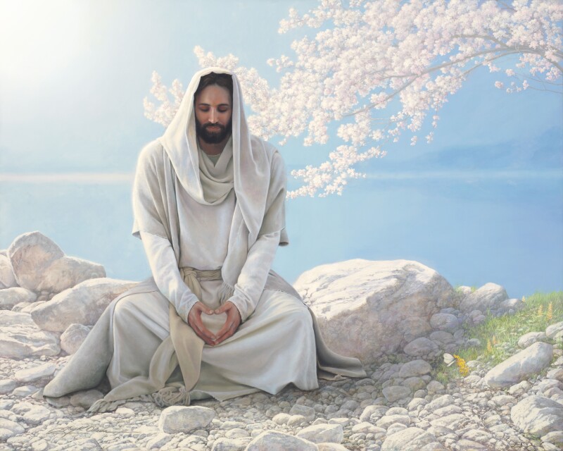 A painting of Christ meditating on a rock surrounded by a tree with blossoms.